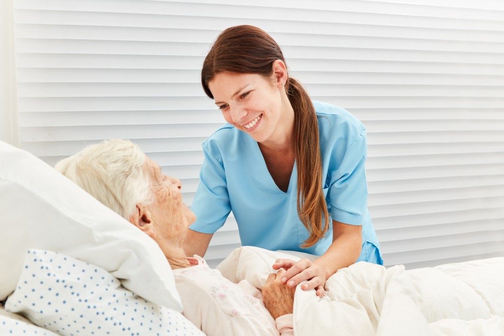 nurse taking care of an elderly