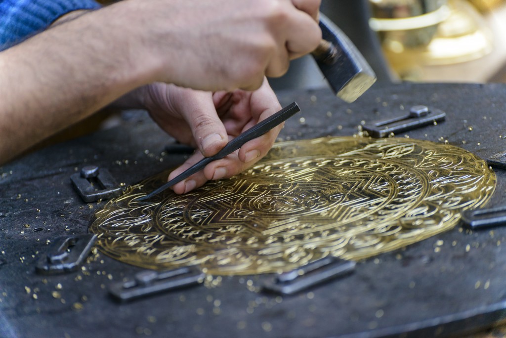 Craftsman engraving a plate