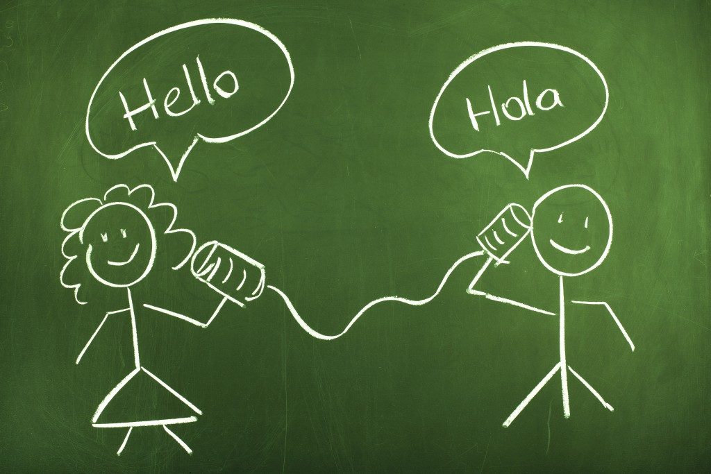 chalk drawing saying hello in spanish and english