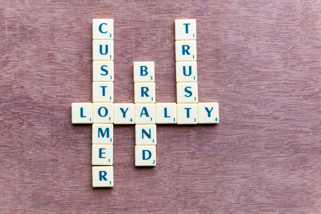 Crossword tiles spelling out customer, loyalty, brand, and trust