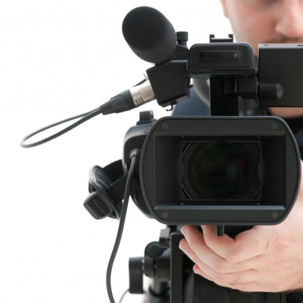 A cameraman holding a video camera