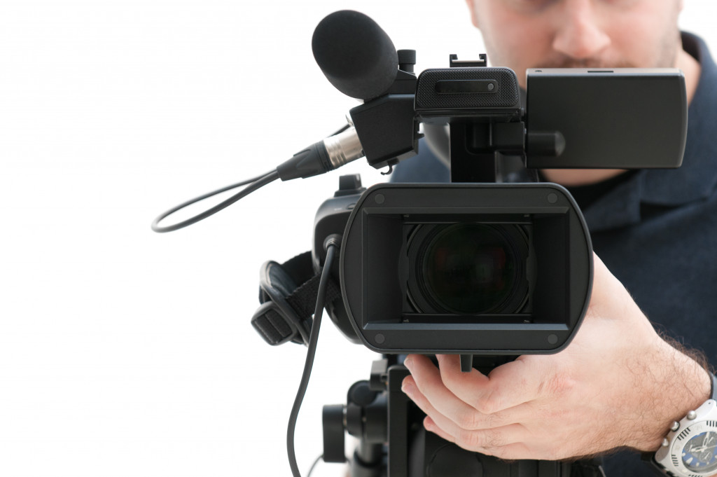 A cameraman holding a video camera