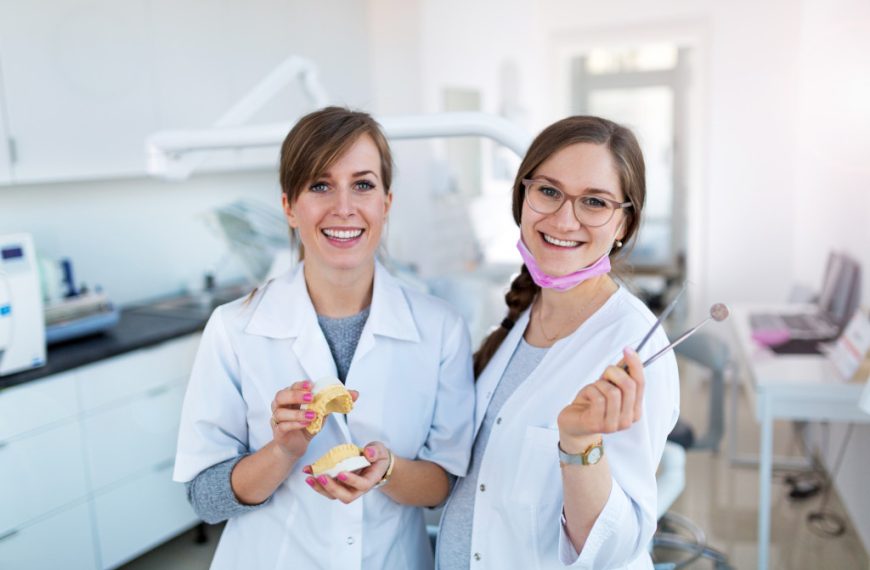 two female dentists holding dental equipment in the room