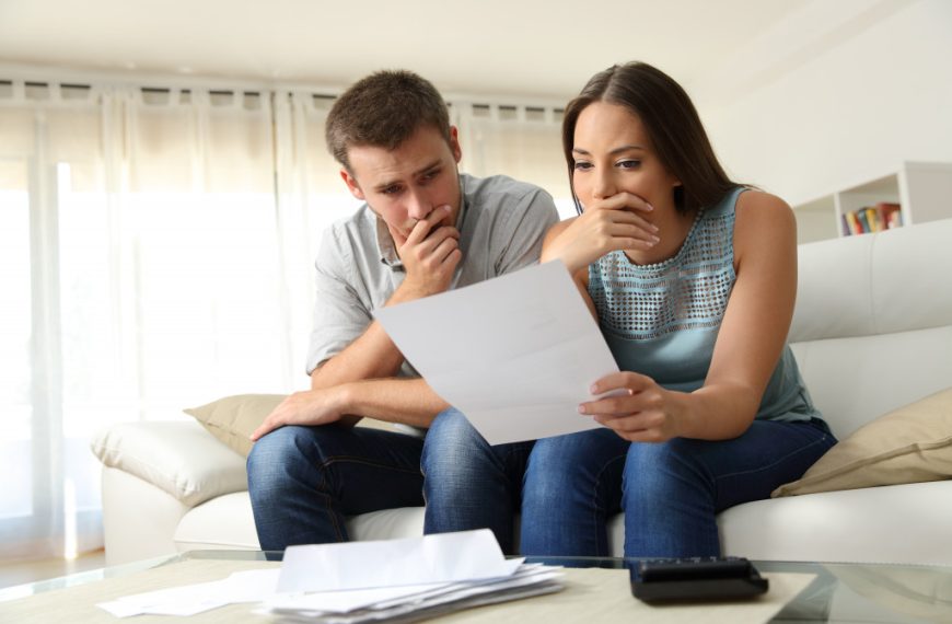 a couple looking at their bills